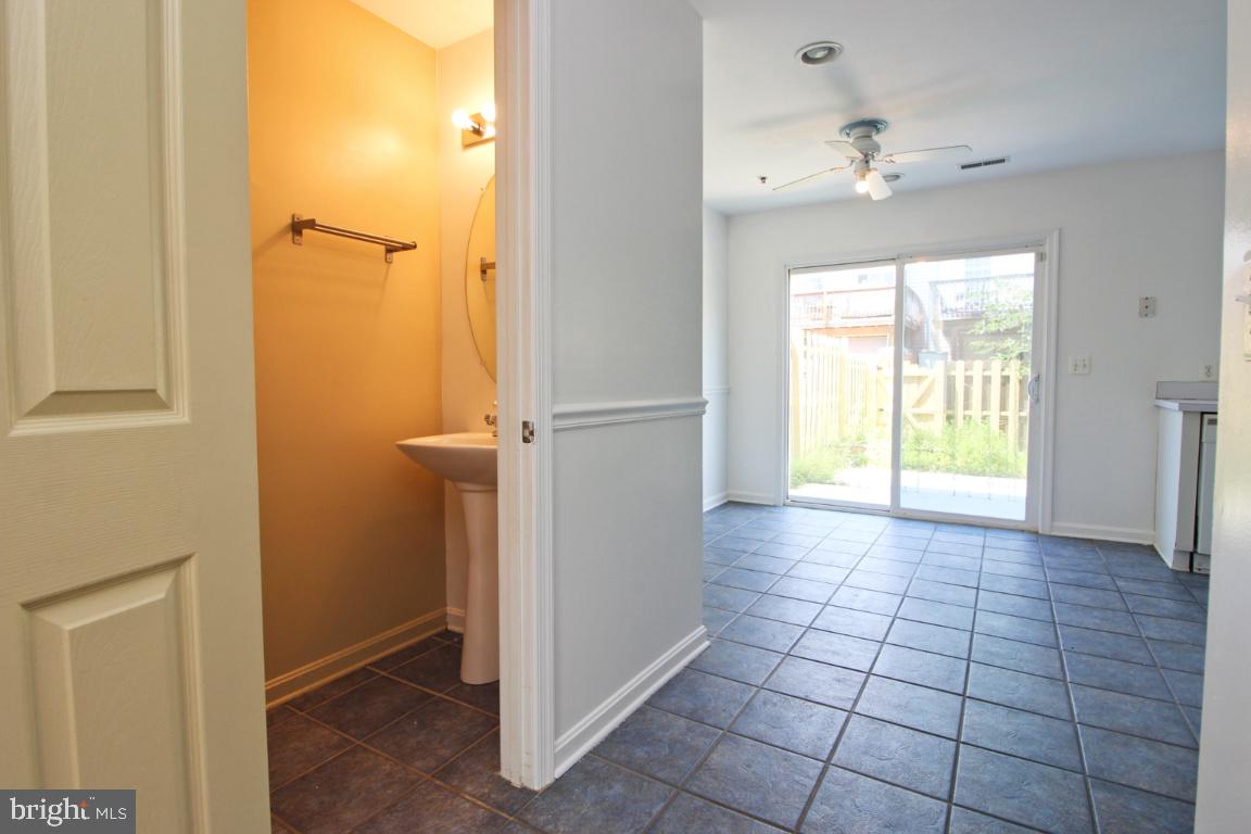 656 Luthardt Road Baltimore, MD 21220 - Photo 7 of 27 a view of an empty room with window and wooden floor