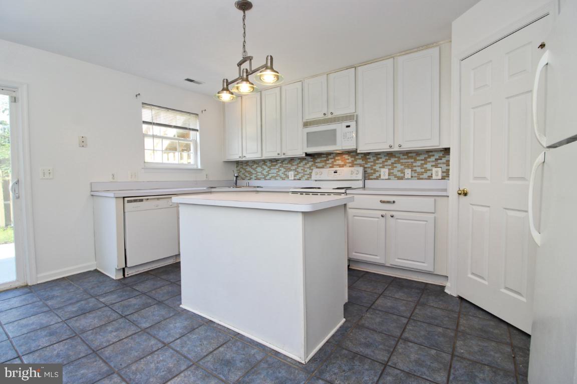 656 Luthardt Road Baltimore, MD 21220 - Photo 9 of 27 a kitchen with a sink stove and cabinets