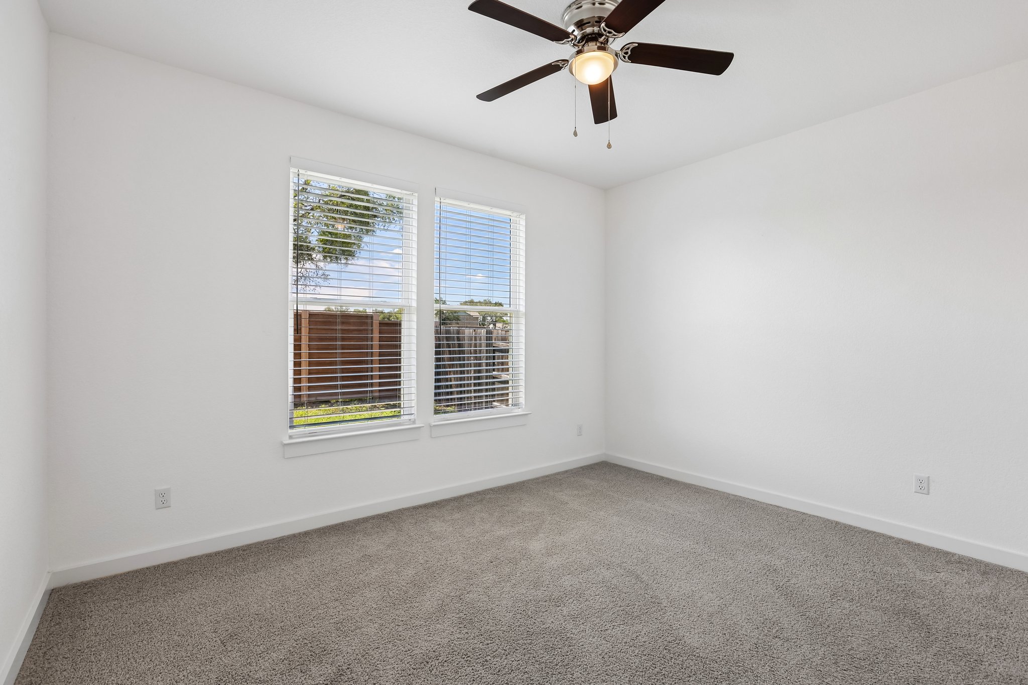 317 Independence Drive Kyle, TX 78640 - Photo 33 of 40 an empty room with a window and a fan