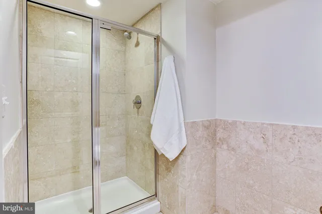 a bathroom with a shower and a glass door
