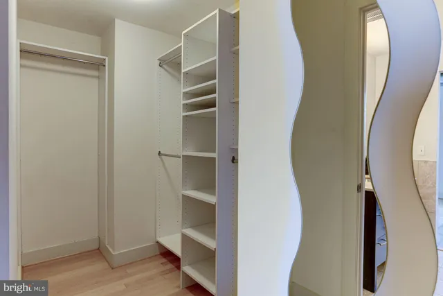 a view of a closet with wooden floor
