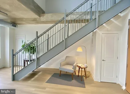 a living room with furniture and a painting on the wall