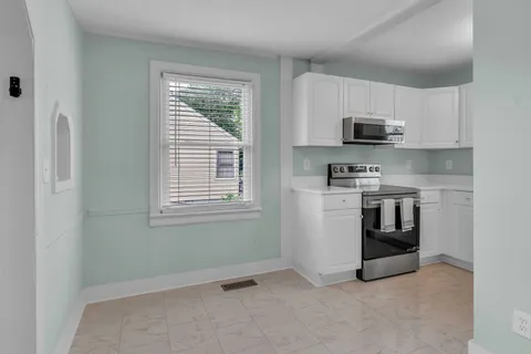 a kitchen with stainless steel appliances a stove a sink and a microwave