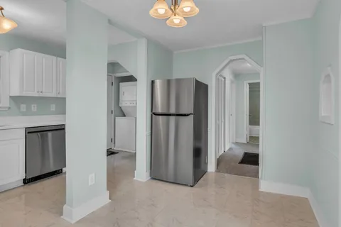 a view of a kitchen with a refrigerator and cabinets