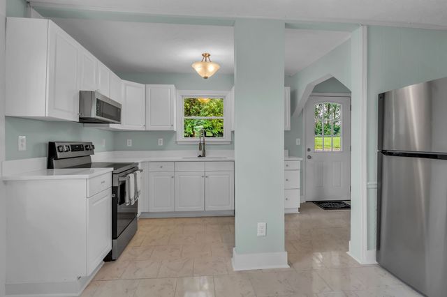 a kitchen with a refrigerator a stove a microwave and cabinets