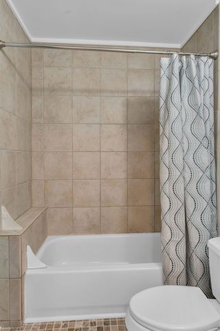 a bathroom with a toilet and a bathtub