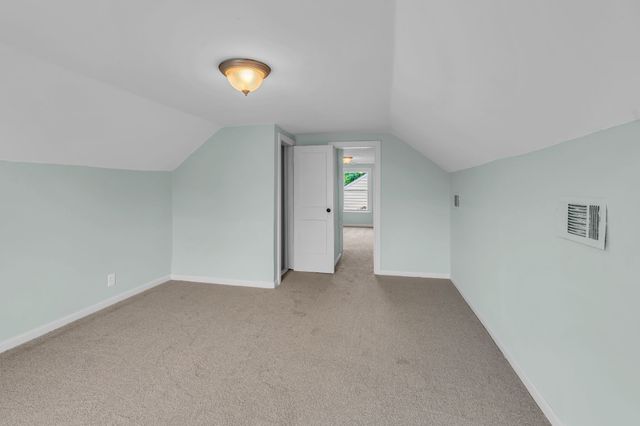 a view of an empty room with wooden floor and windows