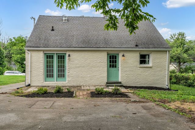 front view of house with potted plants