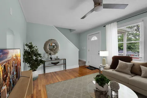 a bedroom with furniture and a large window