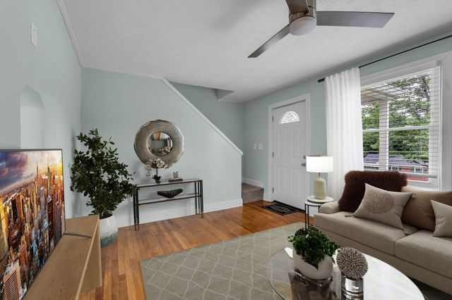 a bedroom with furniture and a large window