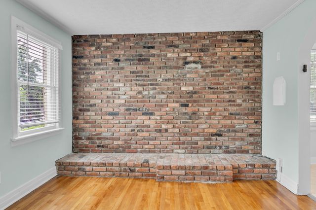 a bathroom with a bathtub and a wooden floor