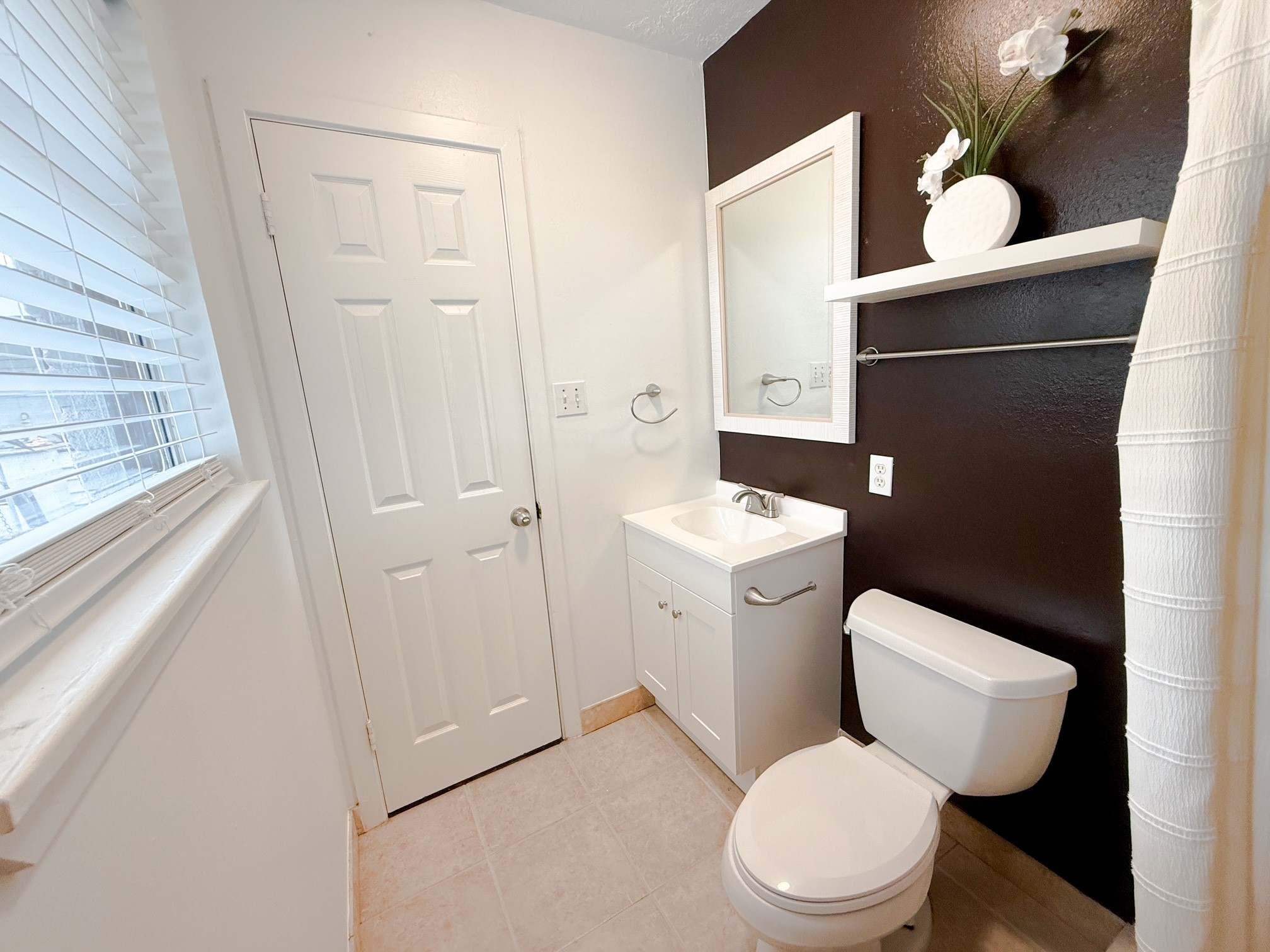124 Bluebird Lane Pasadena, TX 77502 - Photo 7 of 25 a white toilet sitting next to a bathroom sink