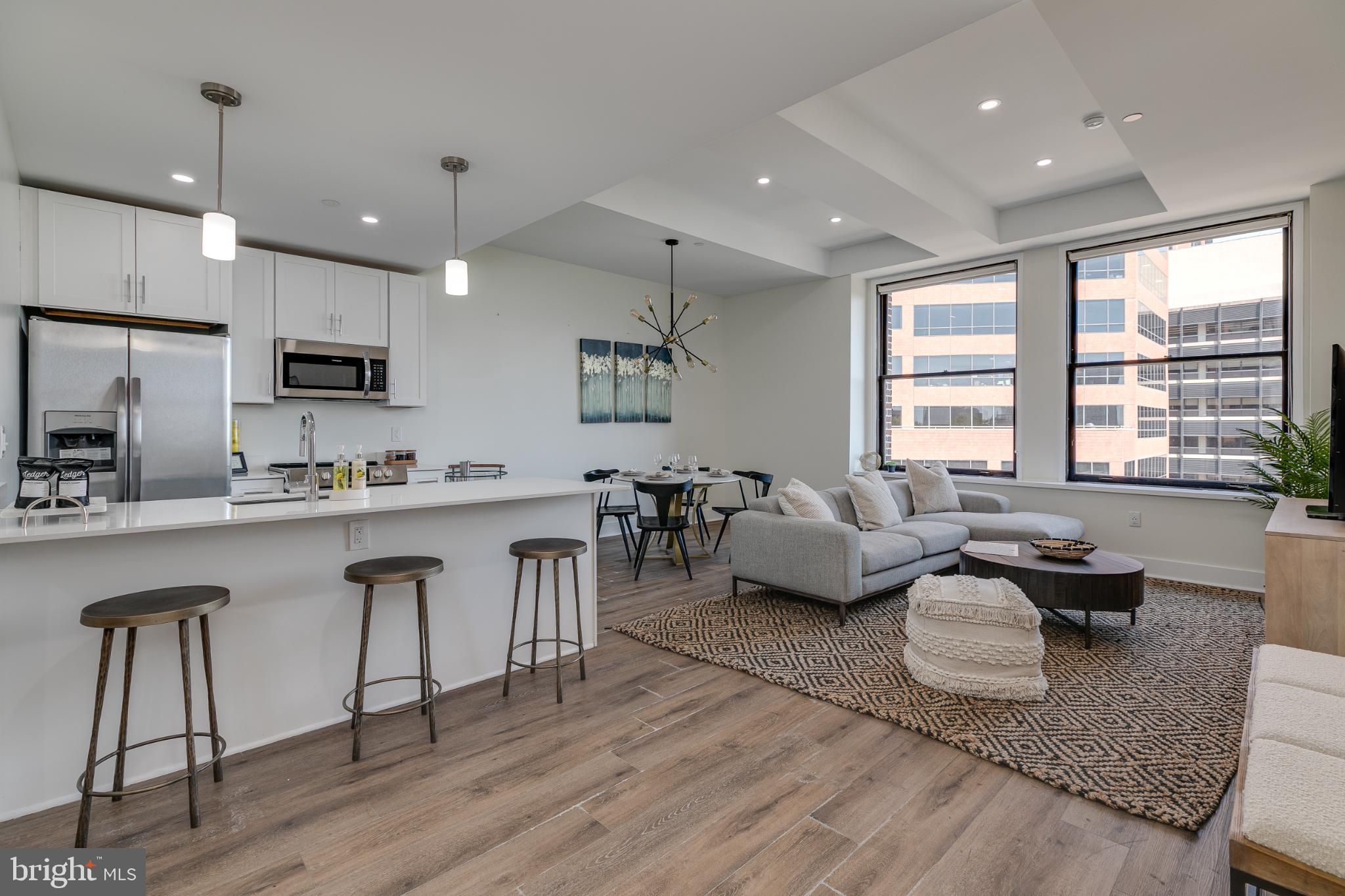 150 South Independence Mall West, Unit 403 Philadelphia, PA 19106 - Photo 16 of 19 a living room with furniture a wooden floor and a sink