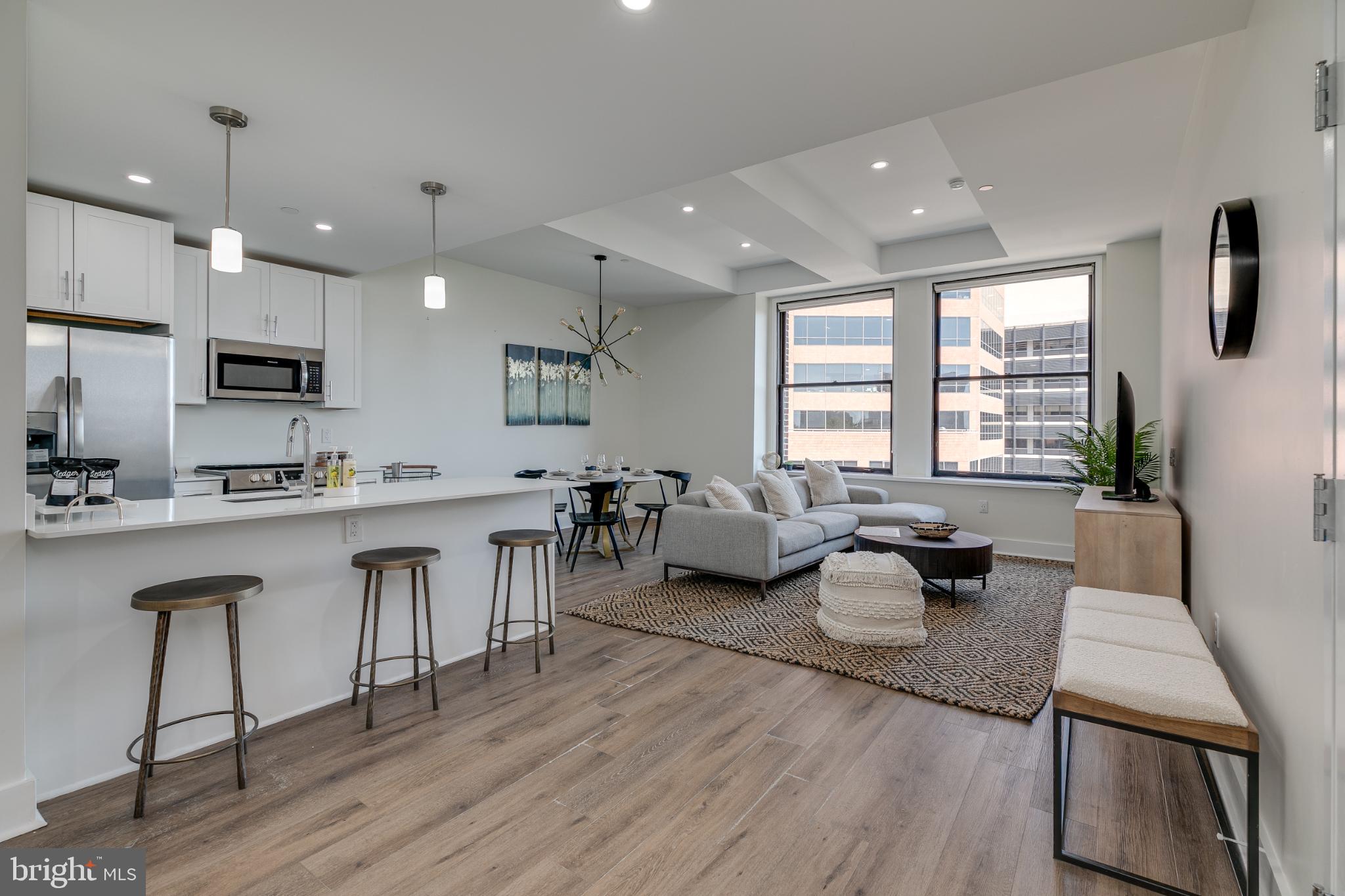 150 South Independence Mall West, Unit 403 Philadelphia, PA 19106 - Photo 7 of 19 a living room with furniture a wooden floor and a large window