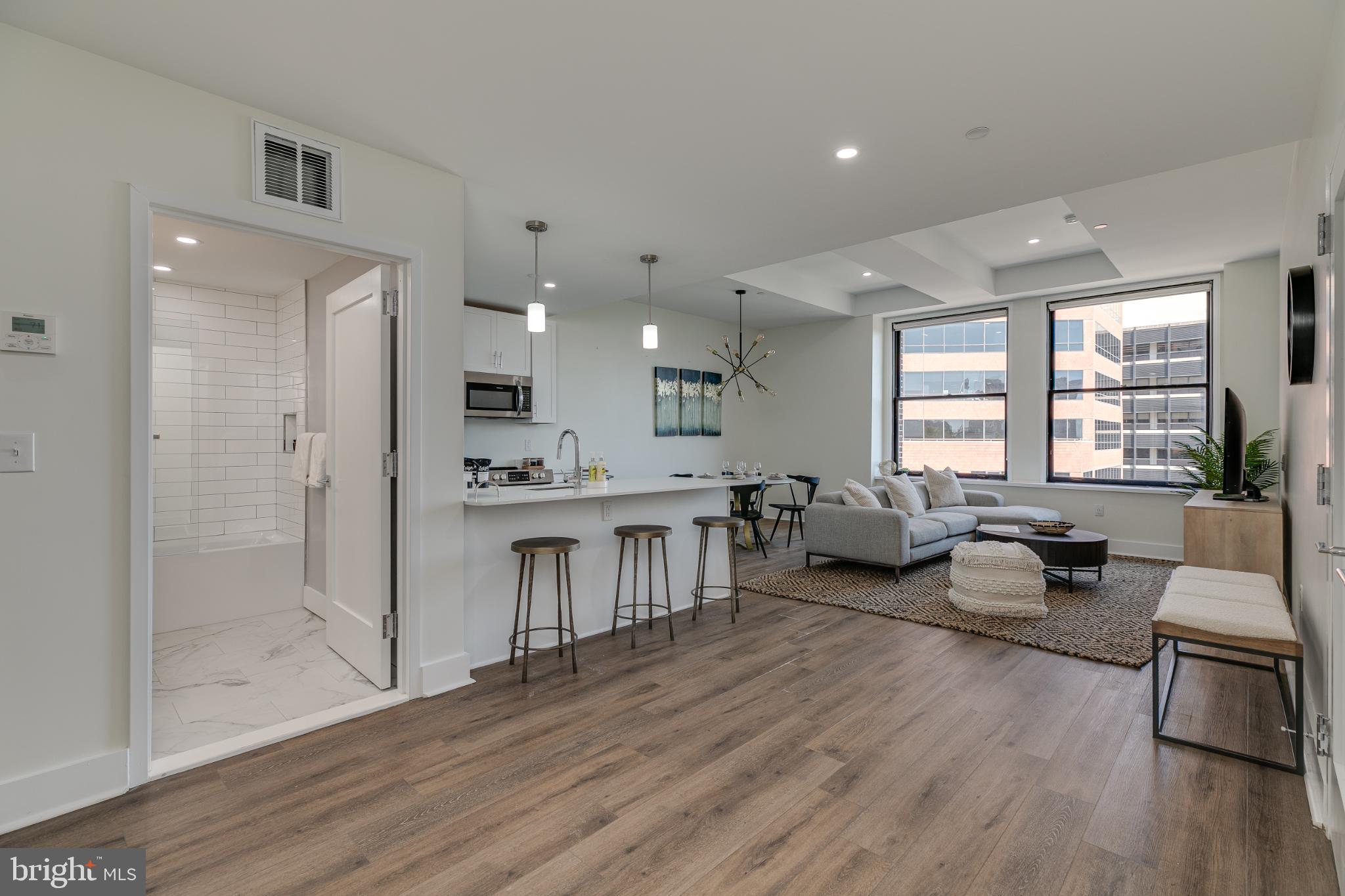 150 South Independence Mall West, Unit 403 Philadelphia, PA 19106 - Photo 8 of 19 a living room with furniture a wooden floor and a large window