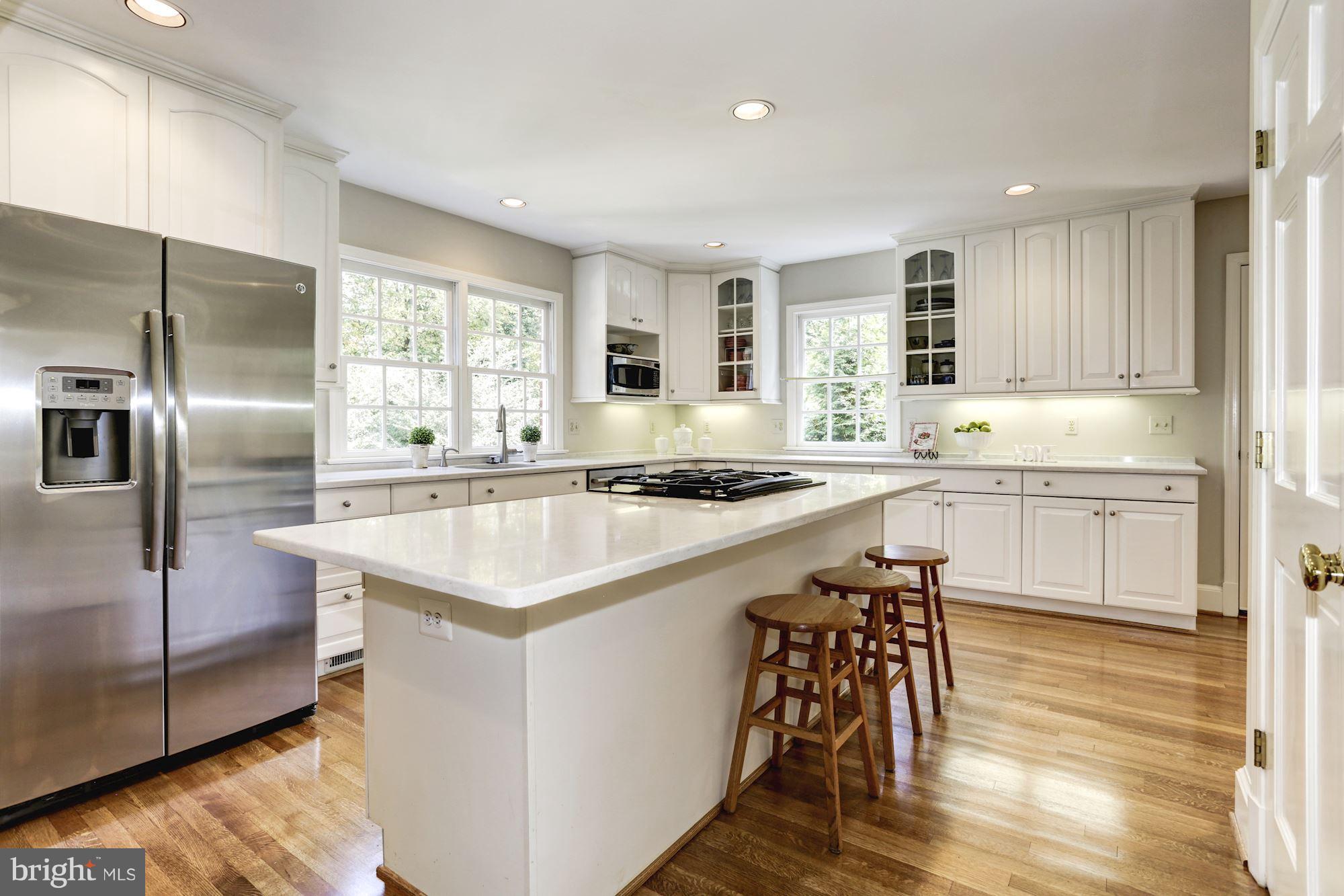 4105 Everett Street Kensington, MD 20895 - Photo 13 of 30 a kitchen with a sink a counter top space cabinets and stainless steel appliances