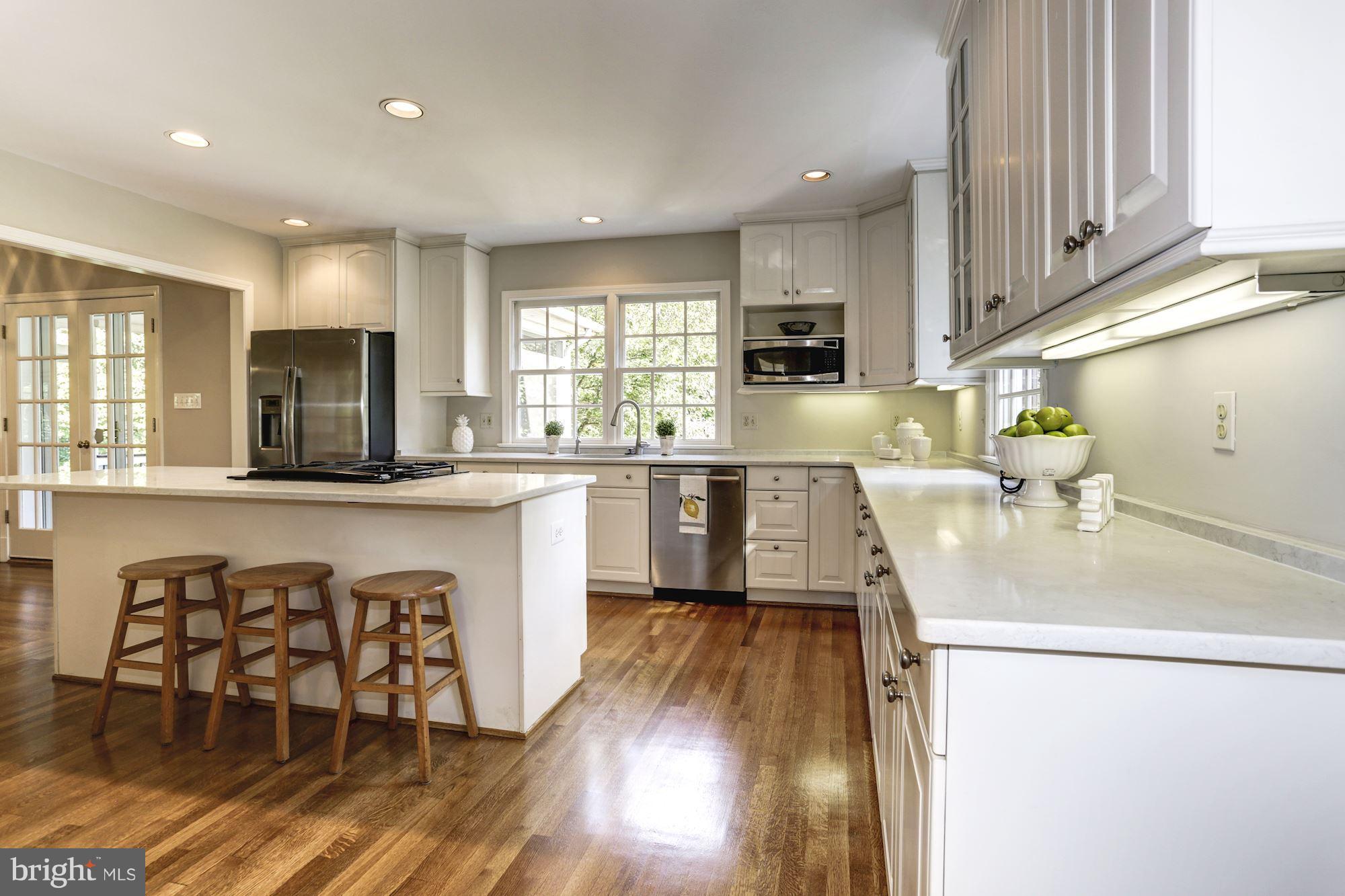 4105 Everett Street Kensington, MD 20895 - Photo 14 of 30 a kitchen with a sink a counter top space cabinets and stainless steel appliances