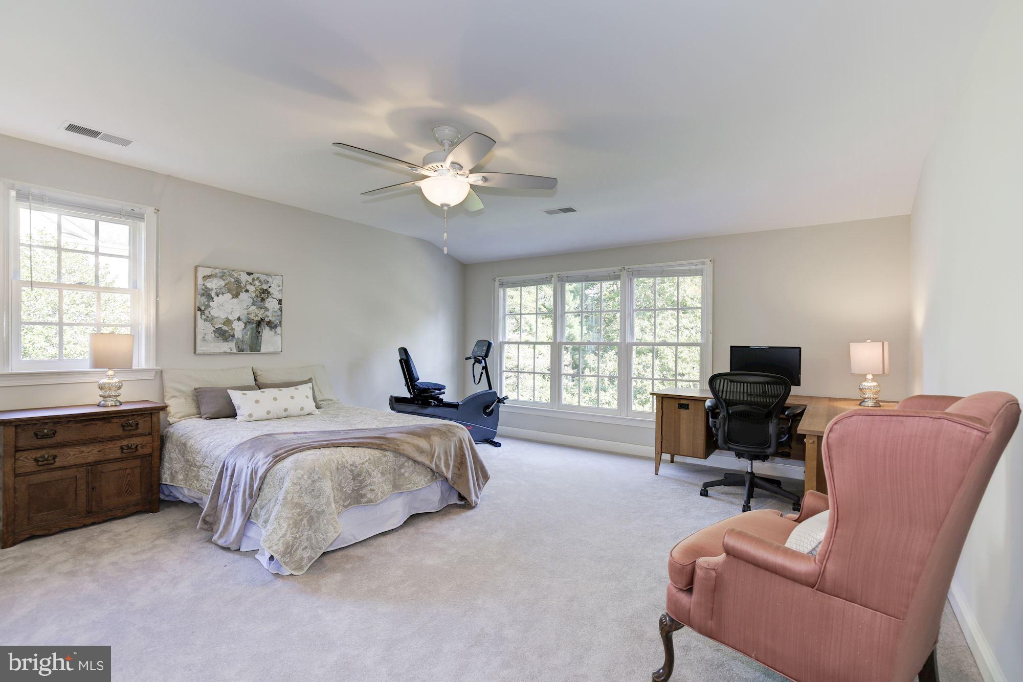 4105 Everett Street Kensington, MD 20895 - Photo 19 of 30 a spacious bedroom with a bed a couch and a large window