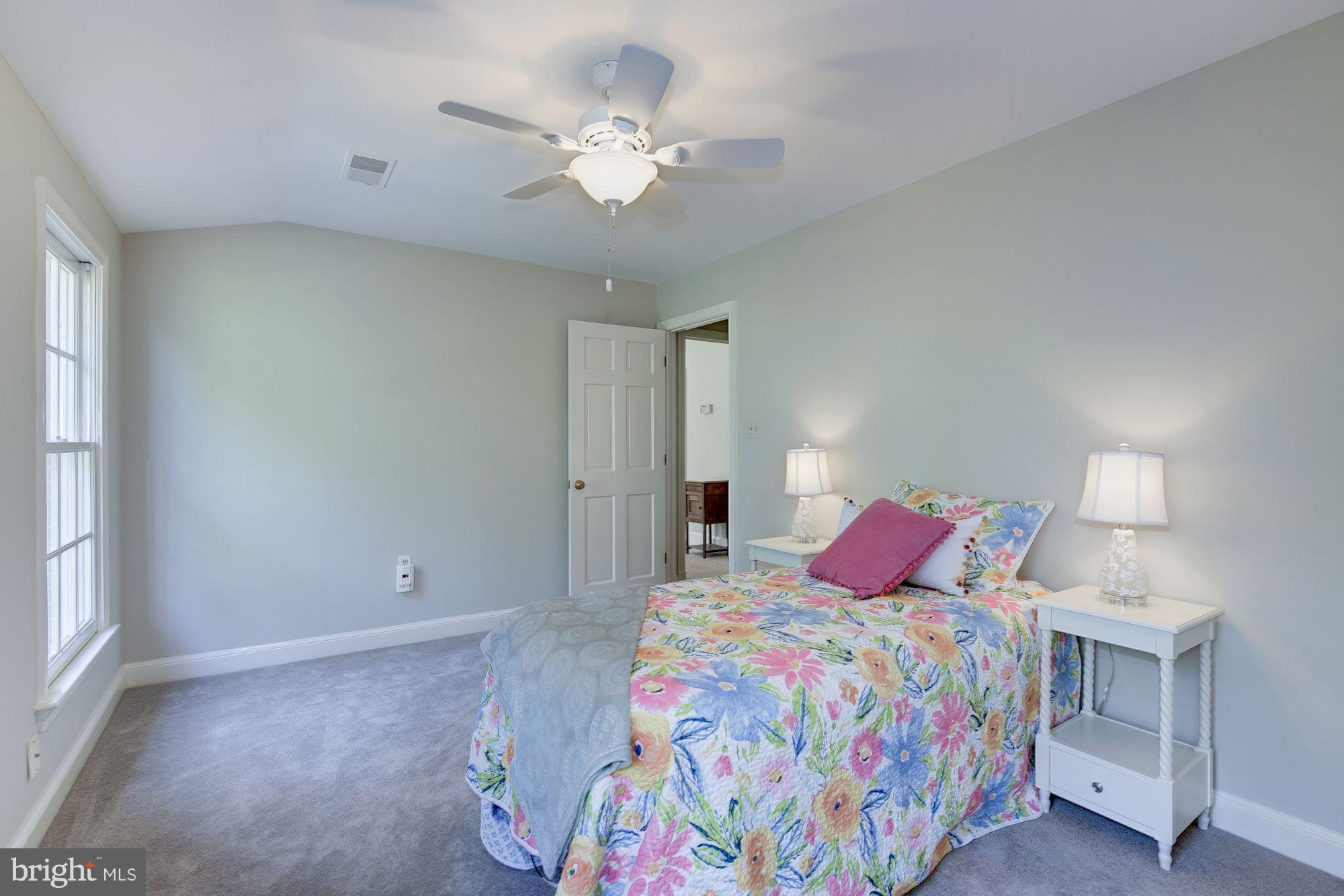 4105 Everett Street Kensington, MD 20895 - Photo 20 of 30 a bedroom with a bed and a chandelier