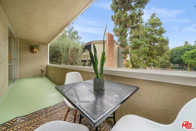 a dining room with furniture and a potted plant