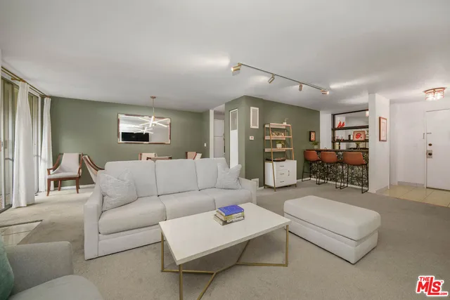 a living room with furniture and kitchen view