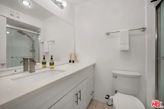 a bathroom with a sink toilet and mirror