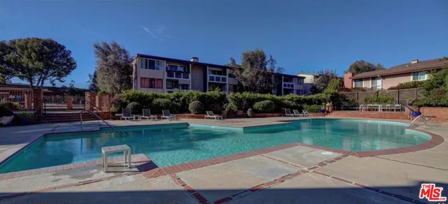a swimming pool with outdoor seating and yard