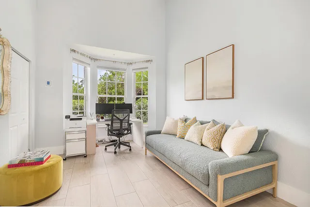 a living room with furniture and a large window