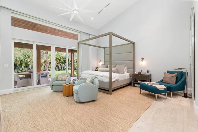 a bedroom with furniture and a large window