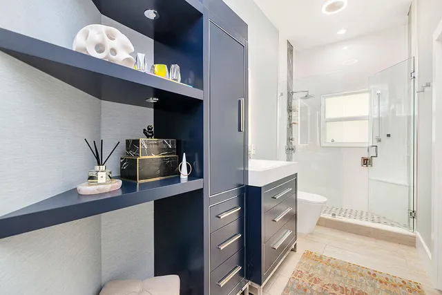 a kitchen with cabinets and wooden floor
