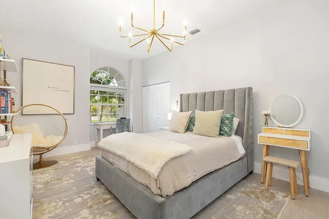 a bedroom with a bed window and a table