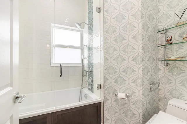 a bathroom with a bathtub and shower