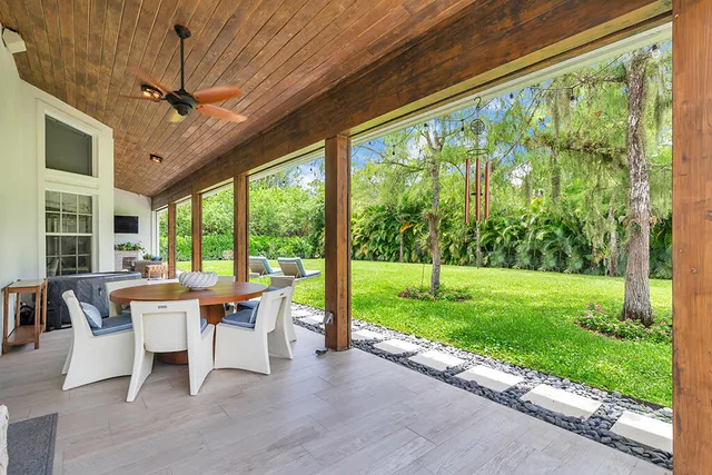 a dining room with furniture and garden view