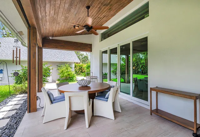 a dining room with furniture and a garden