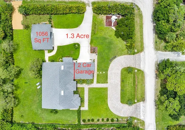 a sign that is on a table with chairs and flower board