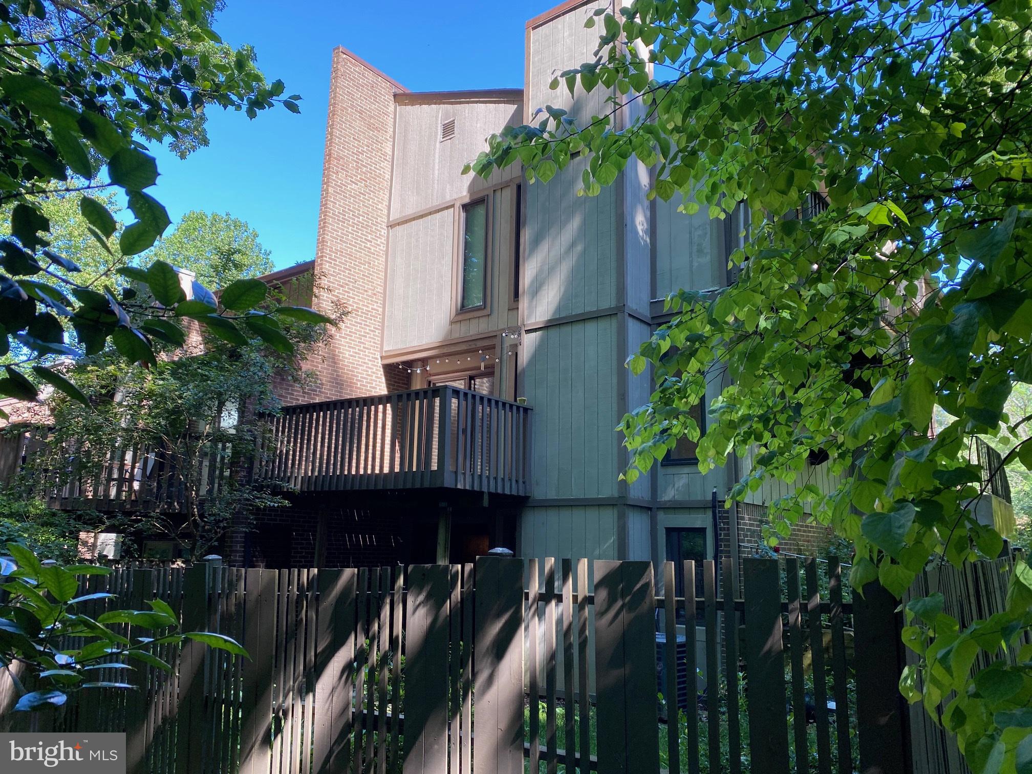 Back of home with bedroom balcony
