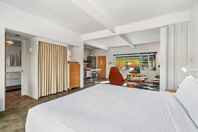 a bed room with a bed and a tv