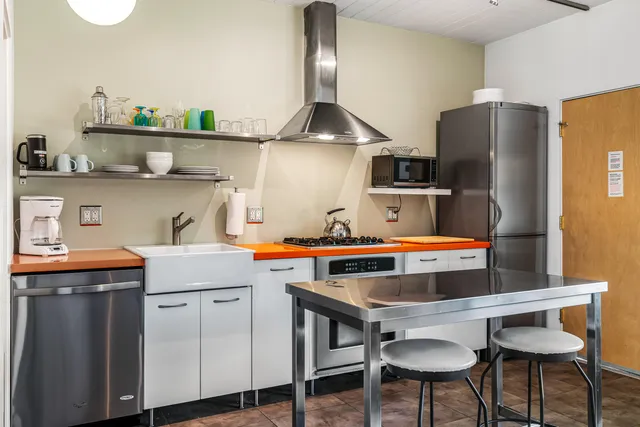 a kitchen with stainless steel appliances a stove and a sink