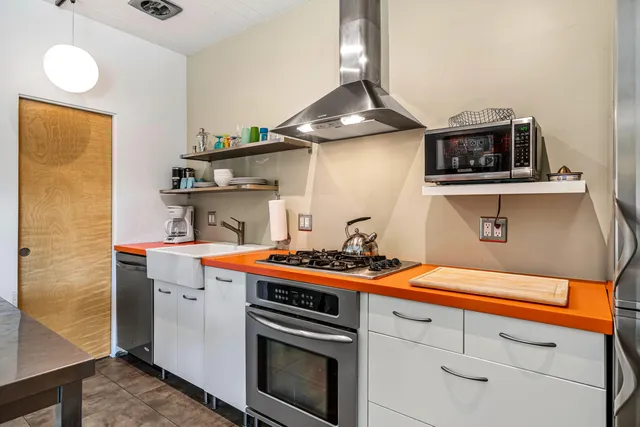 a kitchen with stainless steel appliances a refrigerator and a stove