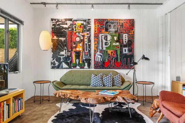 a living room with furniture a rug and a large window