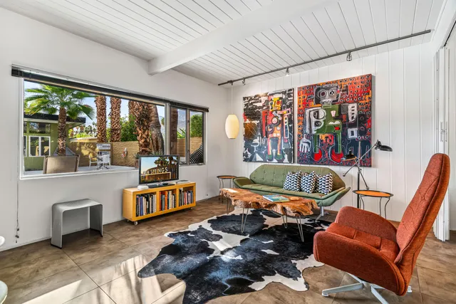 a backyard of a house with table and chairs