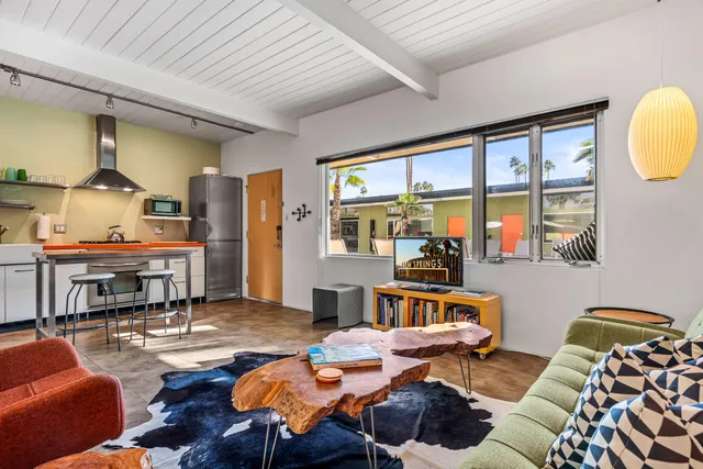 a view of a patio with table and chairs under an umbrella