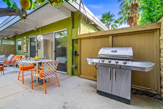 a view of backyard of house with seating space