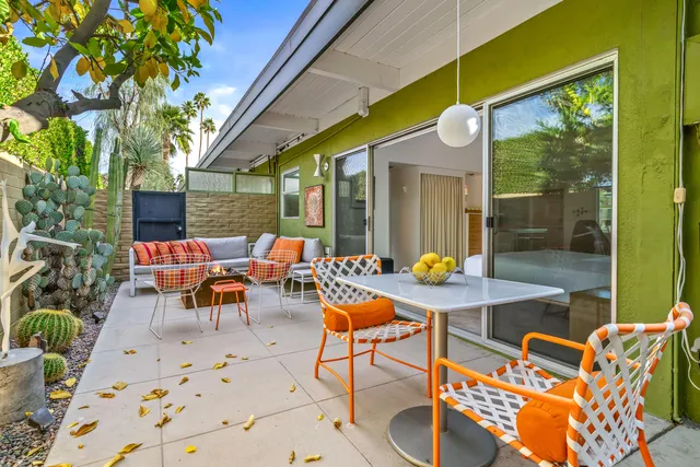 a view of a swimming pool with a table and chairs