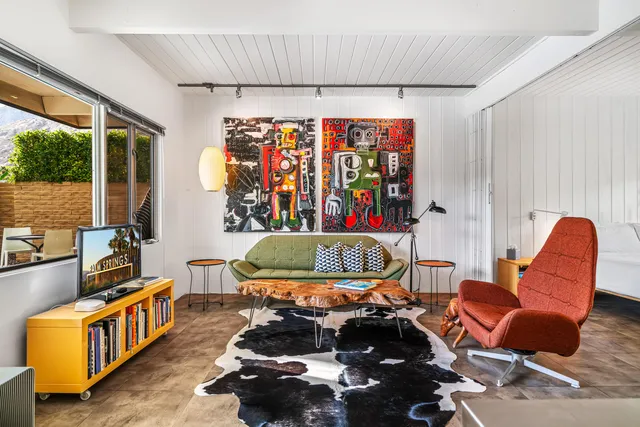 a living room with furniture a rug and a window