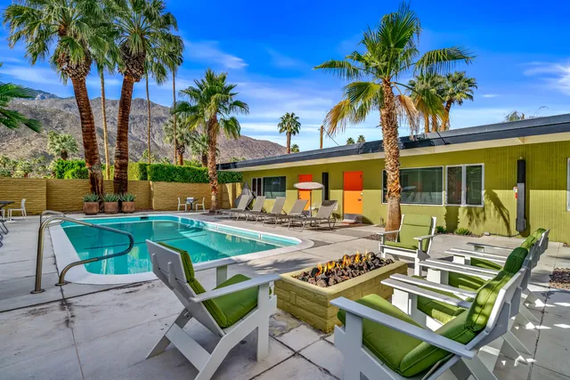 a view of a patio with furniture and a garden