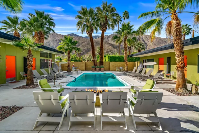 a view of a patio with couches table and chairs and potted plants
