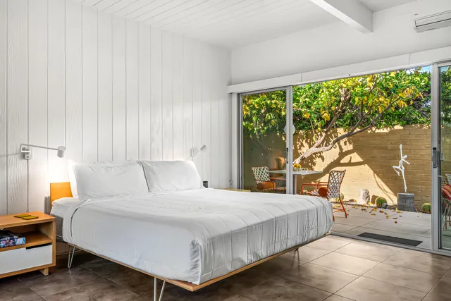 a bedroom with a large bed and a window