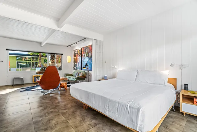 a bedroom with a bed and glass windows