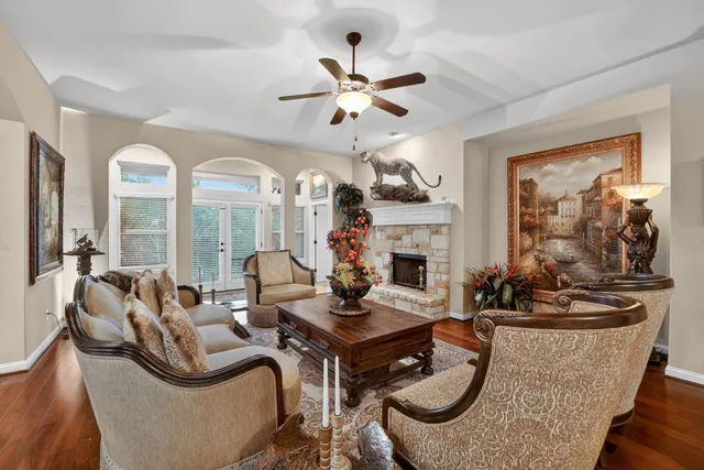 a living room with fireplace furniture and a large window